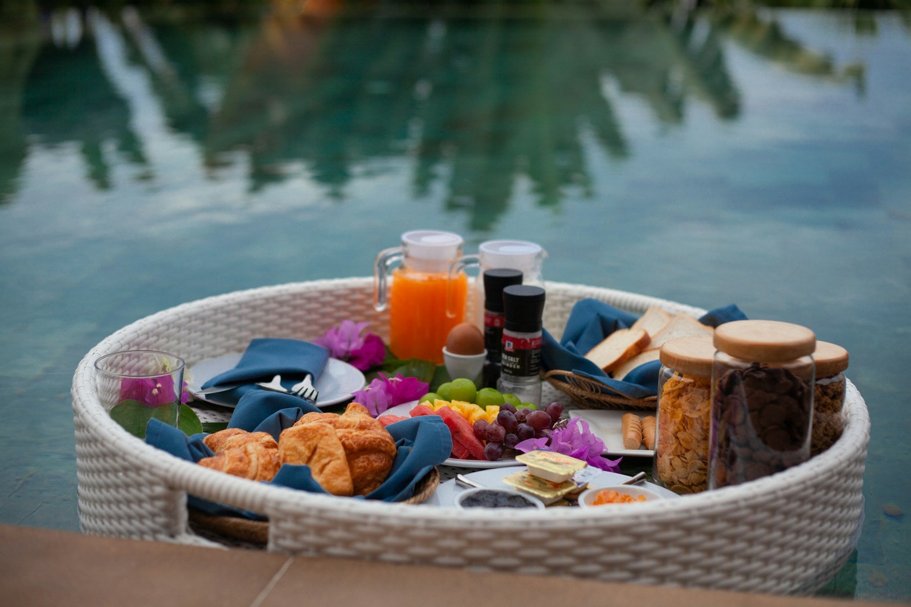 A carefully styled breakfast floating beside a private pool